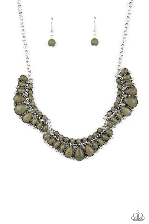 Necklace with green stones and silver chain on a white background