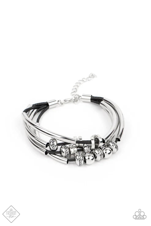 Multi-layered bracelet with black and silver accents on a white background