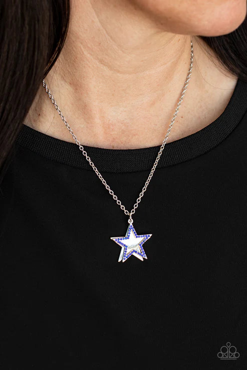 Star-shaped pendant necklace on a person wearing a black top