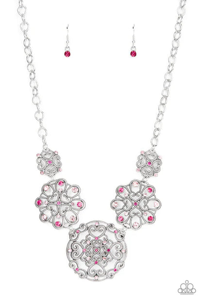Silver necklace with pink gemstones on a white background