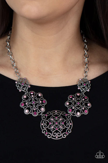 Necklace with pink and clear gemstones on a black background