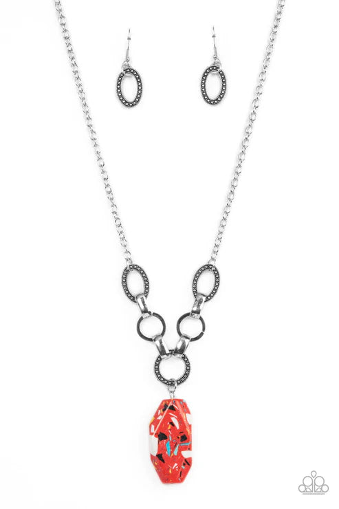 Necklace with red pendant and matching earrings on a white background