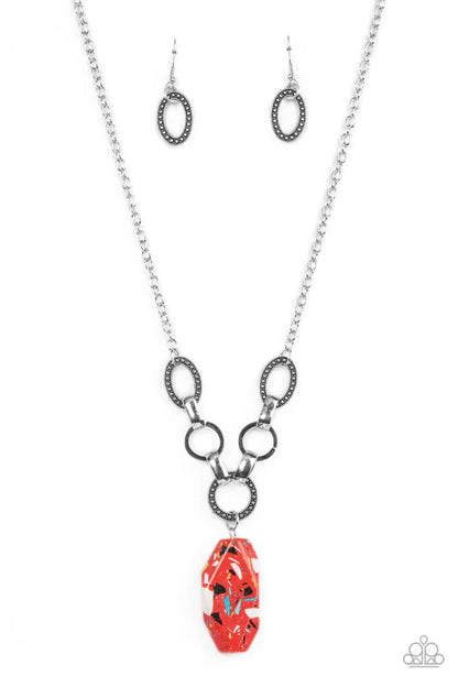 Necklace with red pendant and matching earrings on a white background