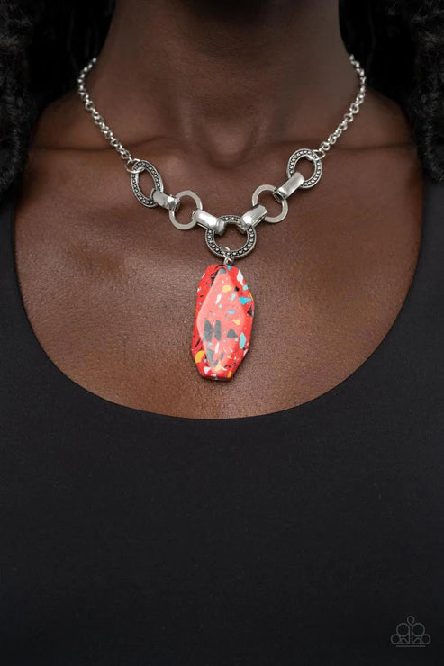 Necklace with a colorful pendant on a dark background