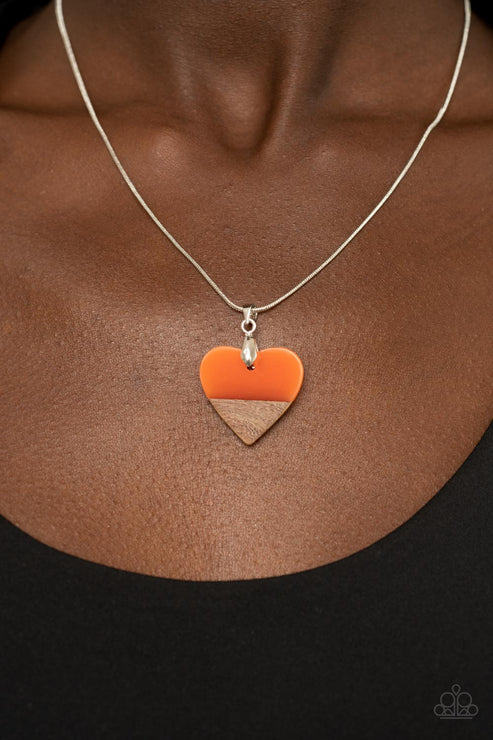 Necklace with a heart-shaped pendant on a brown background