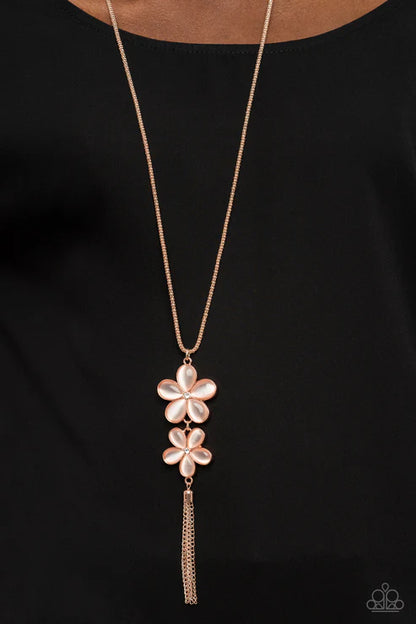Rose gold necklace with floral pendant on a black background