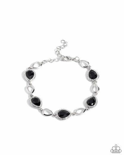 Silver bracelet with black stones on a white background