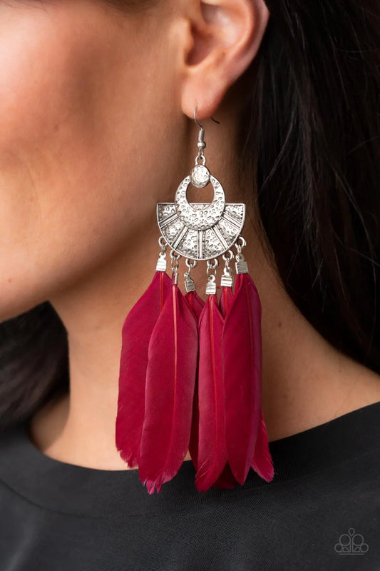 Plume Paradise red feather earrings with hammered silver frames worn by a model