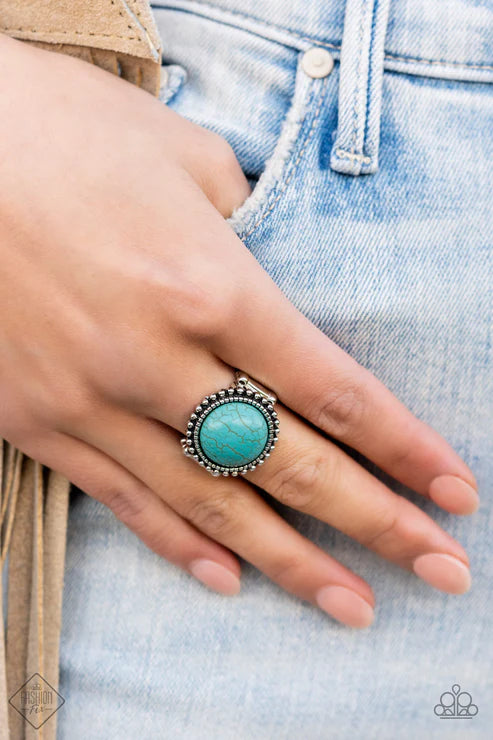 Turquoise ring on a hand with denim background