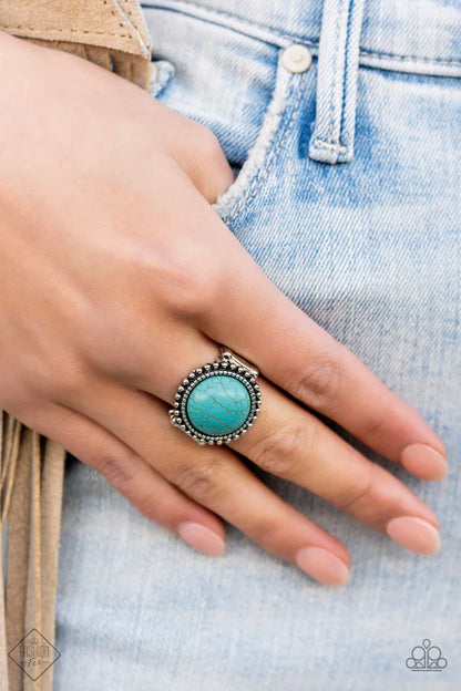Turquoise ring on a hand with denim background