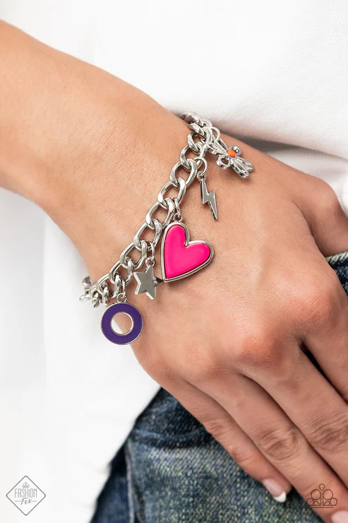 Bracelet with heart charm on wrist against white background