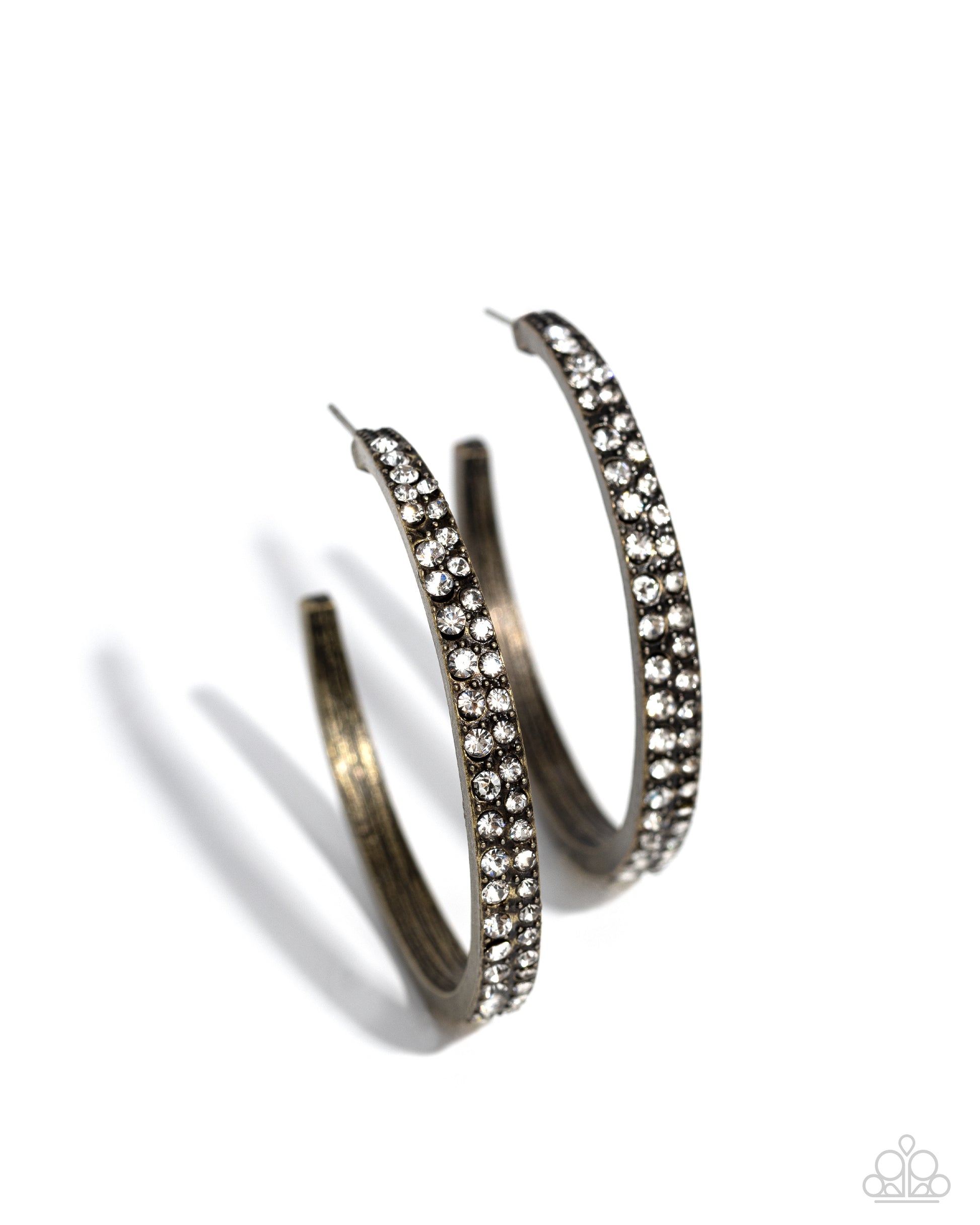 Pair of silver hoop earrings with clear gemstones on a white background