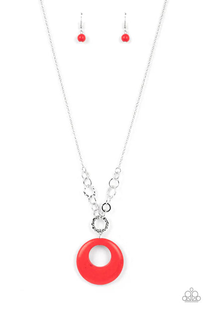 Necklace with a red circular pendant and matching earrings on a white background