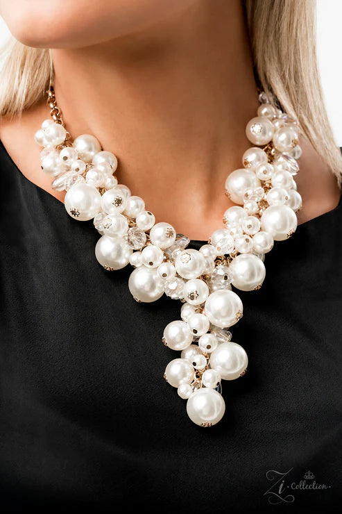Pearl necklace worn by a person on a black background