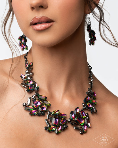 Close-up of a woman wearing a colorful gemstone necklace and earrings on a neutral background.