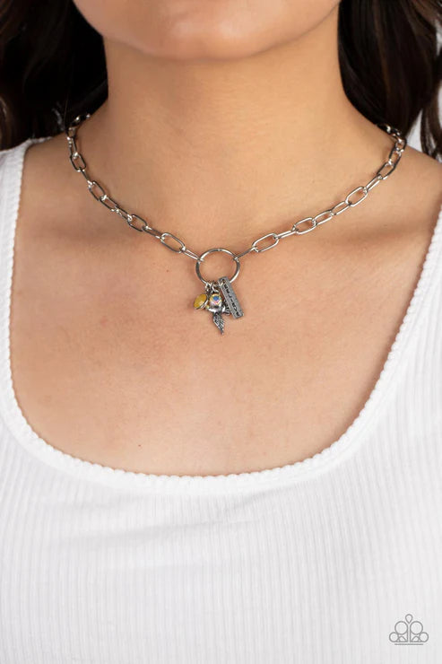 Necklace with a pendant worn by a person against a white background