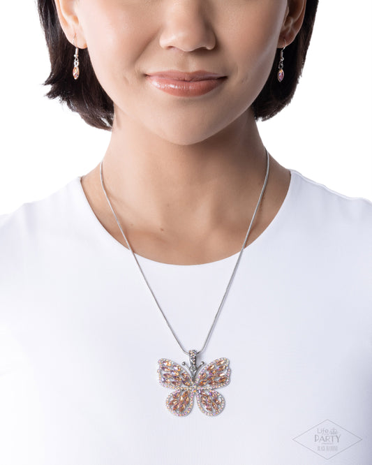 Butterfly necklace worn by a person on a white background