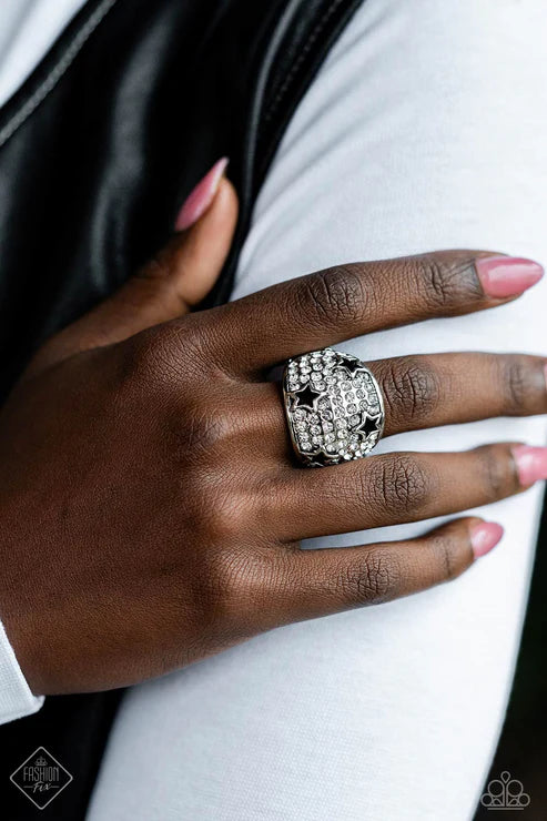 Close-up of a hand wearing a decorative ring on a white background