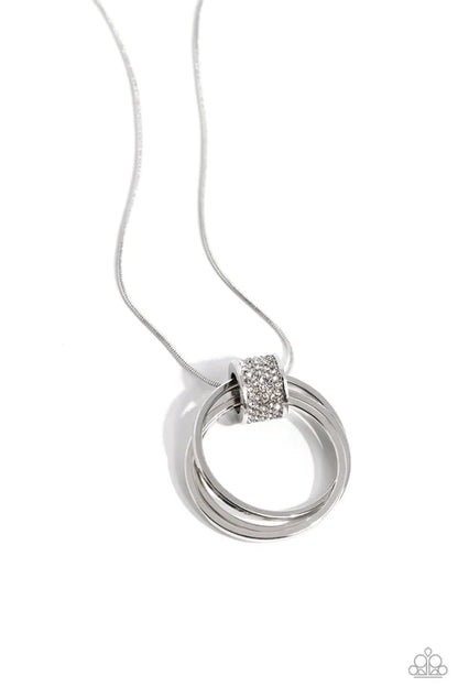 Silver necklace with a circular pendant on a white background