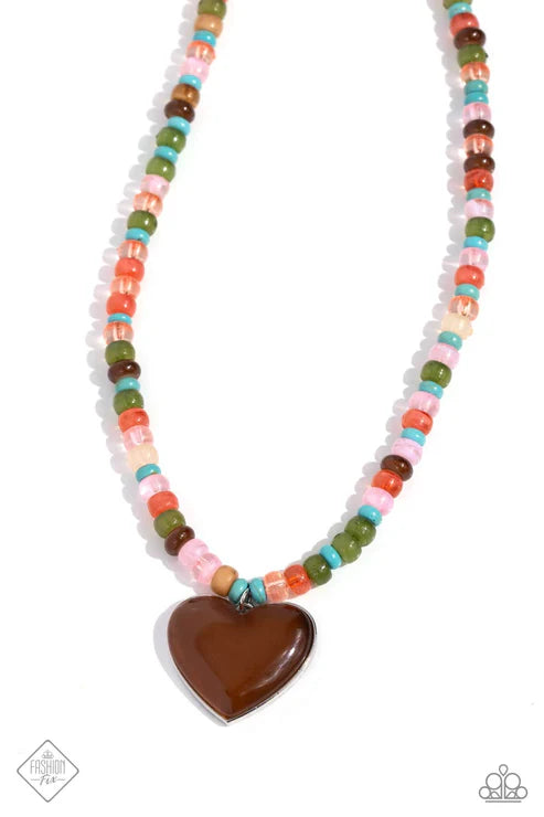 Necklace with colorful beads and a brown heart pendant on a white background