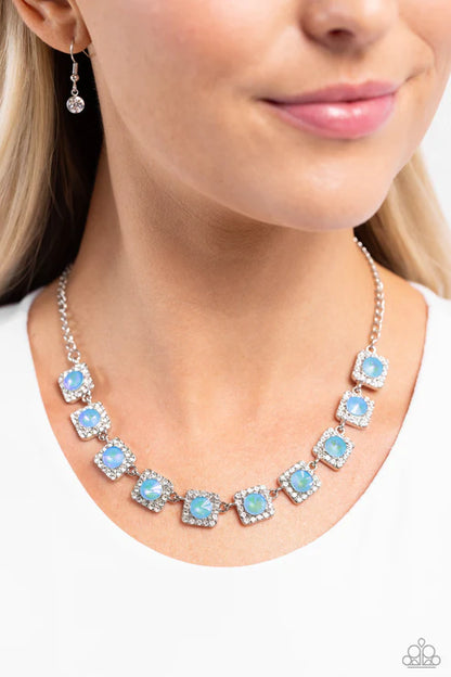 Necklace with blue gemstones worn by a model on a white background