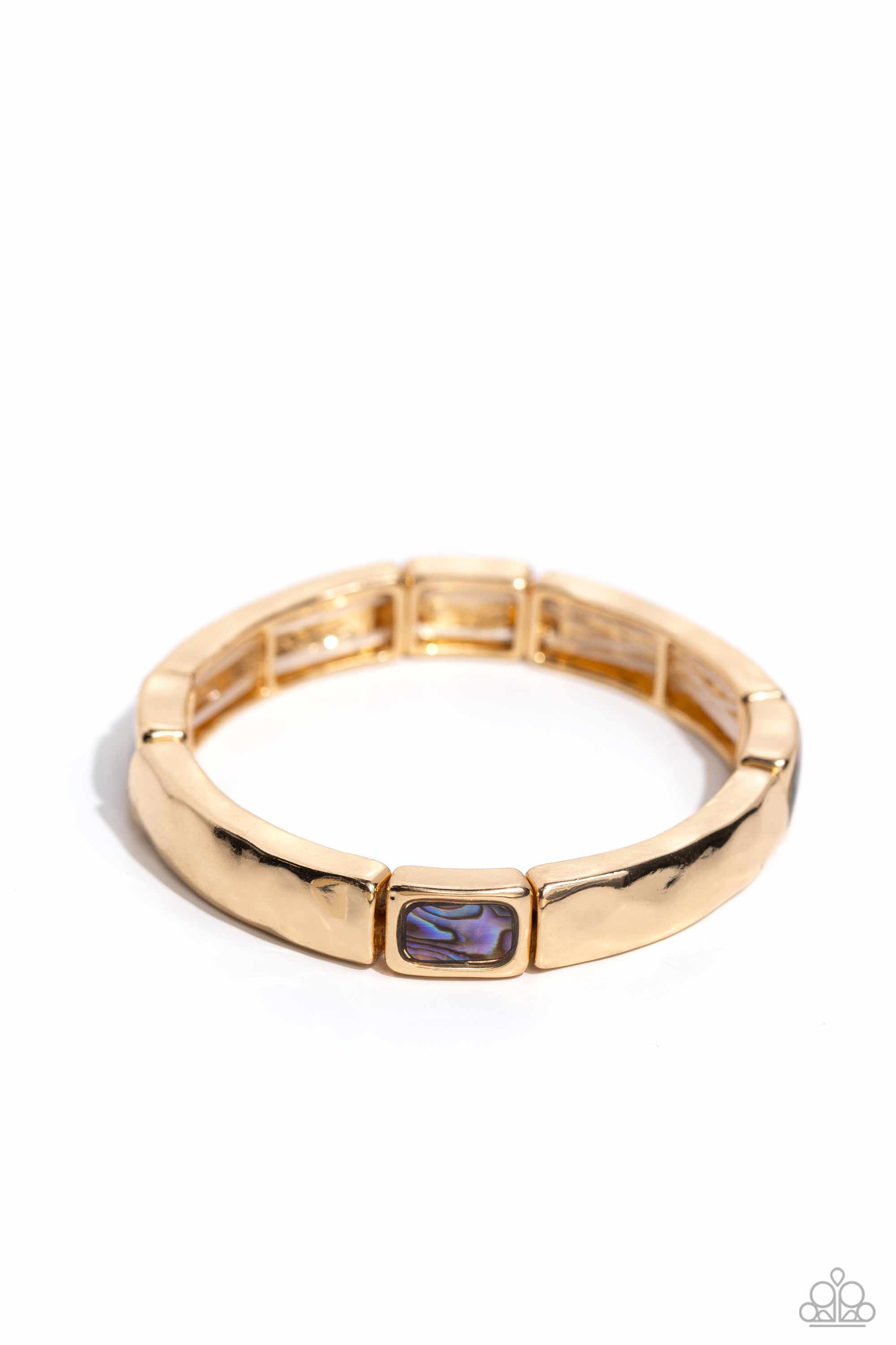 Gold ring with a purple gemstone on a white background
