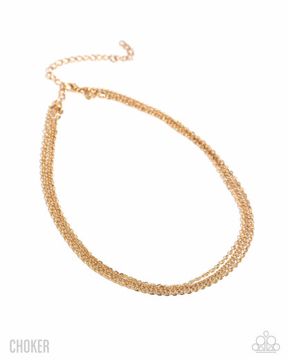 Gold choker necklace on a white background
