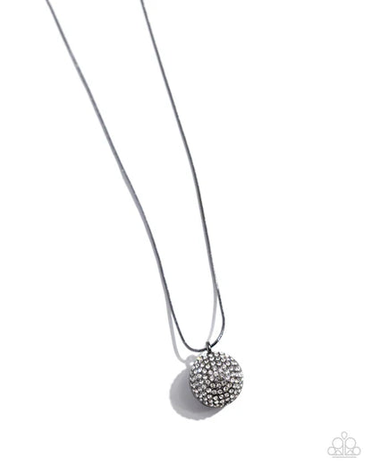Silver necklace with a round, beaded pendant on a white background