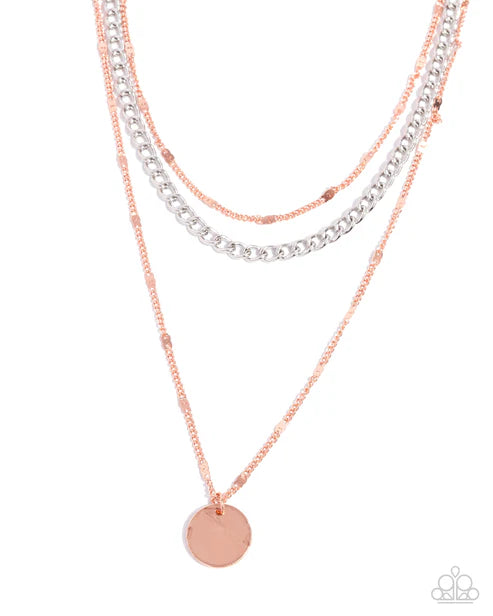 Three layered necklaces with copper silver chains on a white background