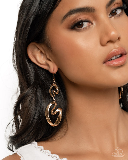 Close-up of a woman wearing gold earrings with a white lace top.