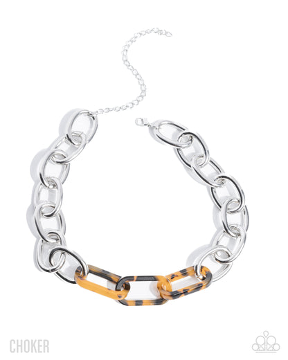 Silver chain choker with tortoiseshell accents on a white background
