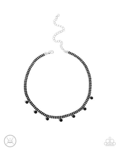 Black beaded necklace on a white background