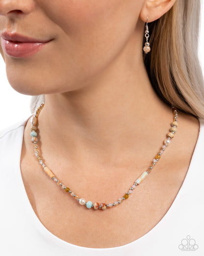 Necklace with multicolored beads worn by a model on a white background