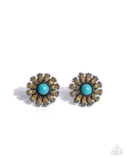 Pair of earrings with turquoise center and brown accents on a white background