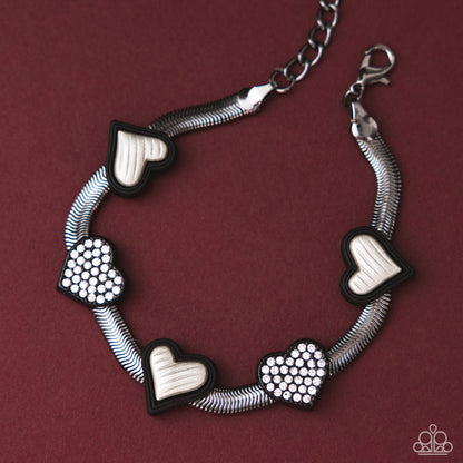 Bracelet with heart-shaped charms on a maroon background