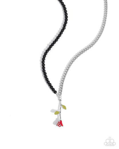 Necklace with black beads and colorful pendant on a white background