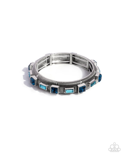 Silver bracelet with blue stones on a white background