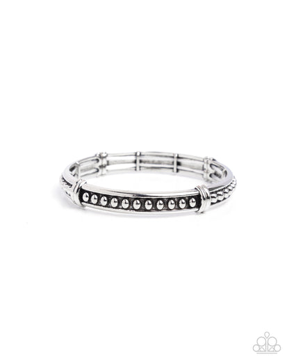 Silver bracelet with black accents on a white background