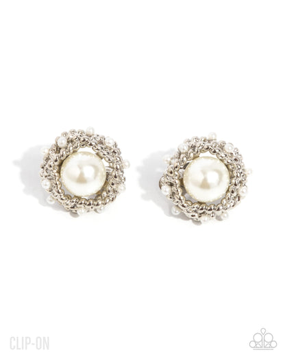 Pair of pearl clip-on earrings on a white background