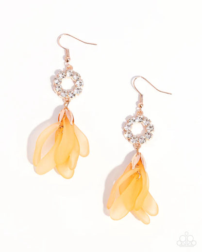 A pair of dangle earrings with rose gold hooks, clear rhinestone-rimmed circular hoops, and translucent yellow-orange petal charms, shown on a clean white background.