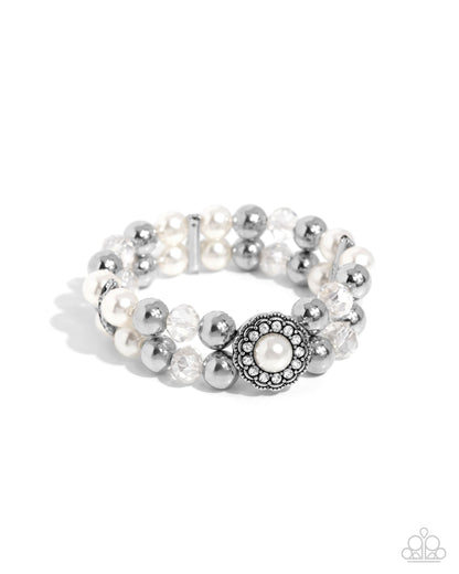 Silver and pearl beaded bracelet on a white background