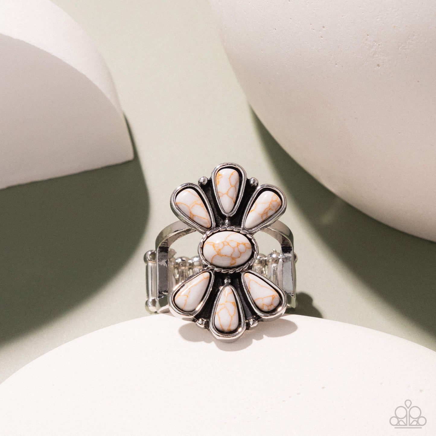 Silver ring with white stones on a light background