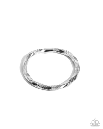 Silver bracelet with textured design on a white background