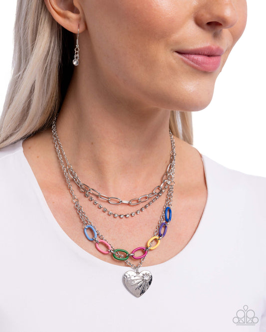 Woman wearing a colorful layered necklace with a white background