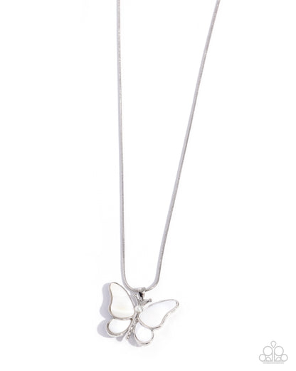 A silver butterfly pendant necklace with white enamel inlay, suspended from a delicate silver chain against a plain white background.