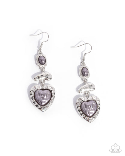 Heart-shaped earrings with purple stones on a white background