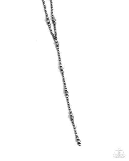 Silver beaded necklace on a white background