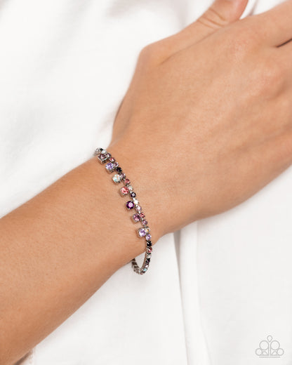 Bracelet with multicolored beads on a wrist against a white background