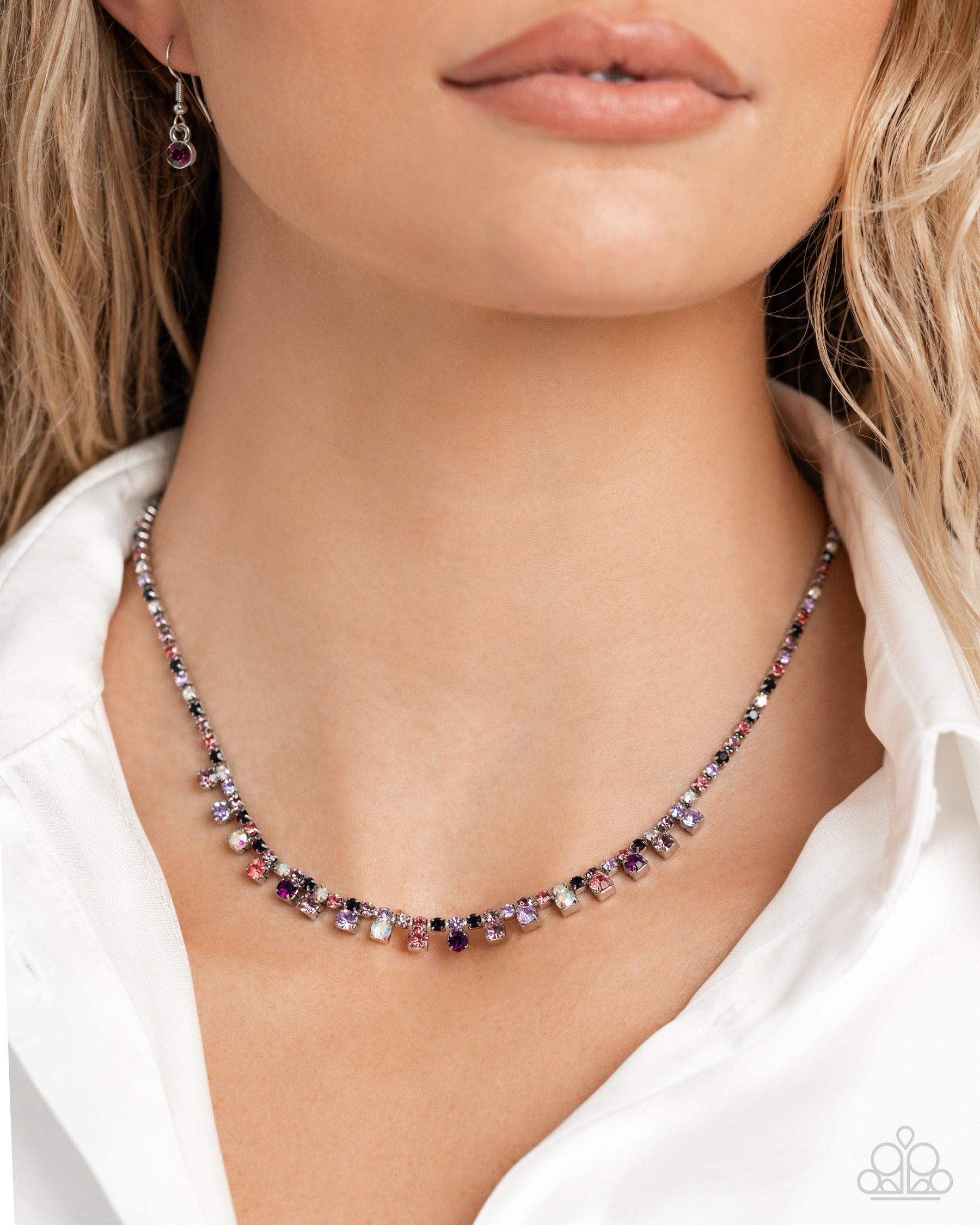 Necklace with multicolored beads worn by a model against a neutral background