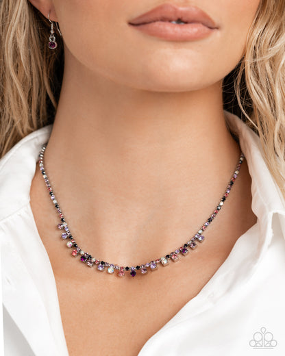 Necklace with multicolored beads worn by a model against a neutral background